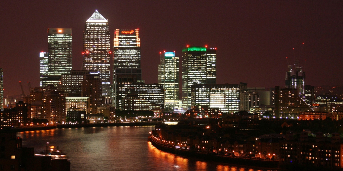 Night time image of Canary Wharf, London. Designed by Studio U+A