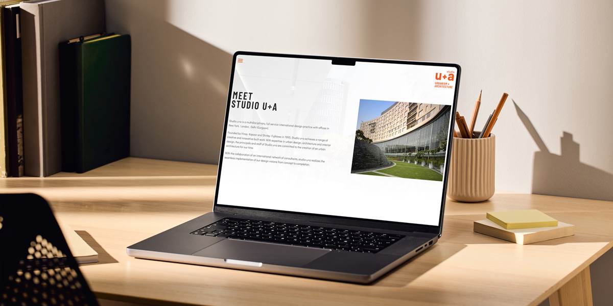 Laptop mockup showing website content for Studio U+A